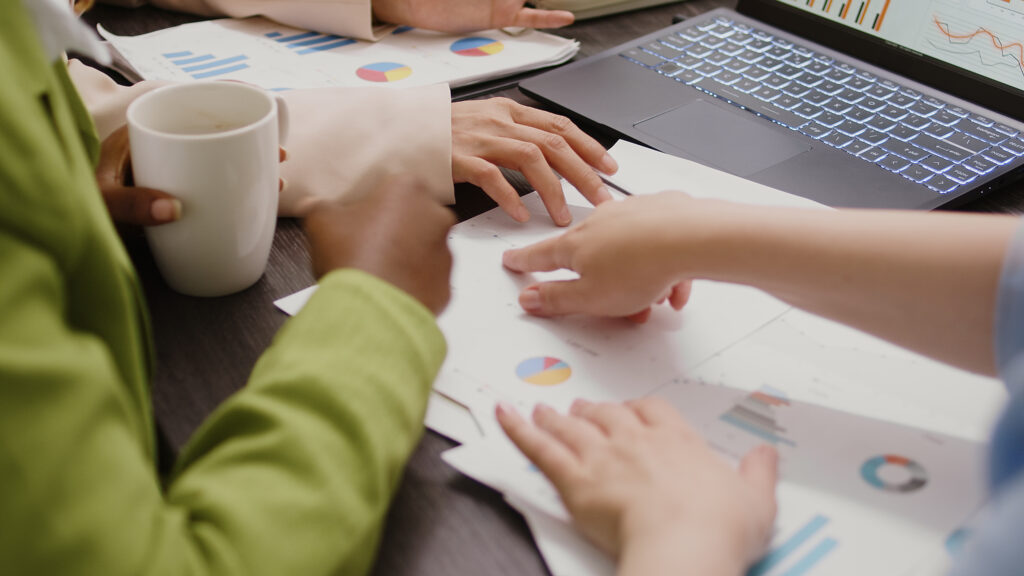 diverse-women-analyzing-data-statistics-documents-looking-papers-find-new-business-solutions-briefing-meeting-boardroom-group-employees-discussing-marketing-vision-close-up